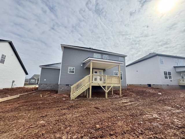 rear view of house with crawl space and stairway