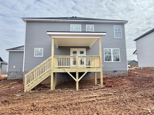 rear view of house with crawl space, stairway, and a wooden deck