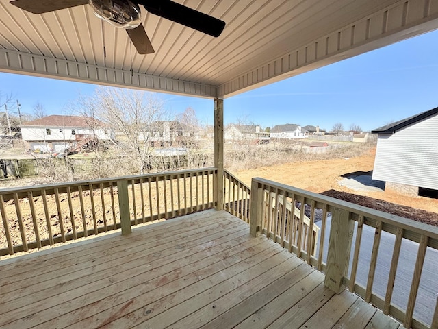 wooden terrace featuring a residential view and a ceiling fan