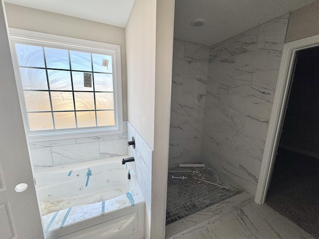 bathroom with a jetted tub, marble finish floor, and a marble finish shower