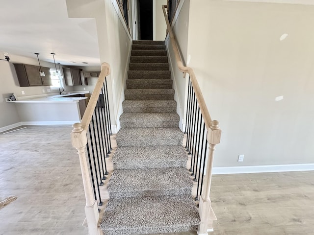 stairs featuring baseboards and wood finished floors