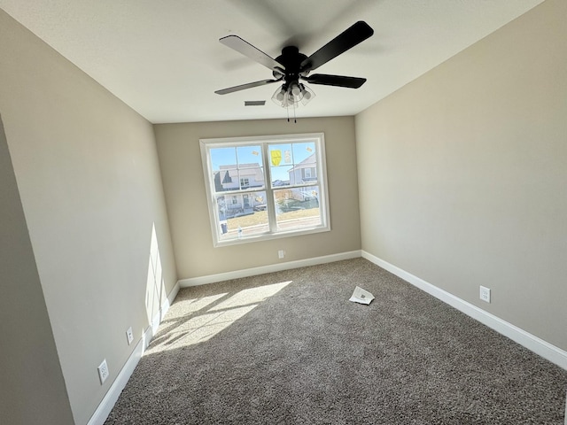 spare room with visible vents, baseboards, ceiling fan, and carpet flooring