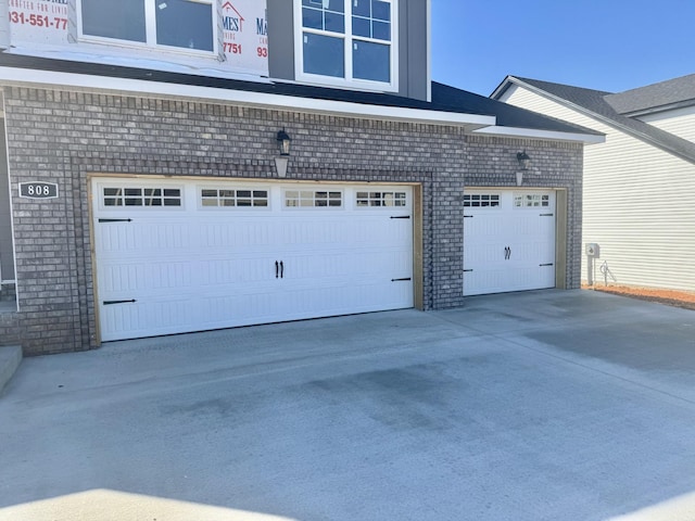 garage with concrete driveway