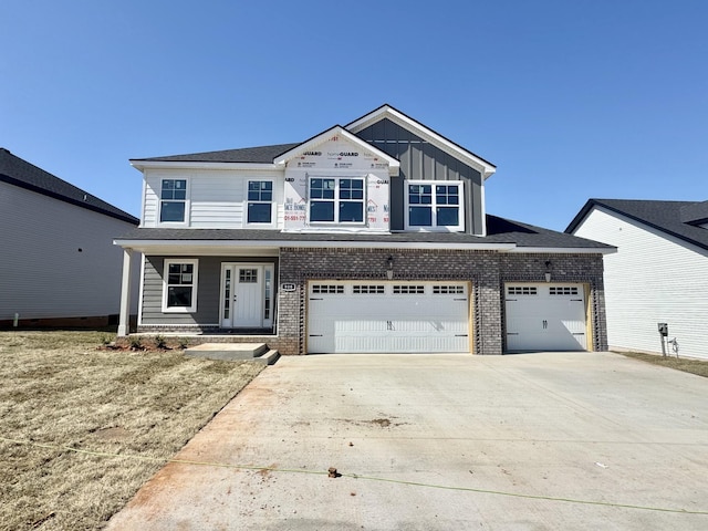 view of front of home with brick siding, board and batten siding, concrete driveway, and an attached garage