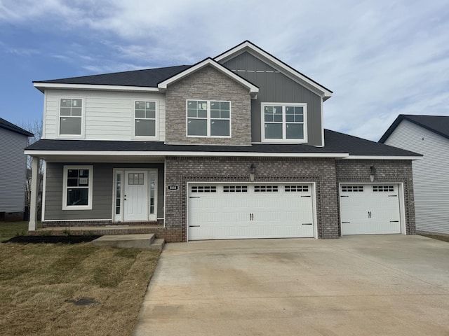 view of front of property with brick siding, a front lawn, an attached garage, and driveway