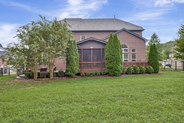 view of side of home featuring a sunroom and a yard