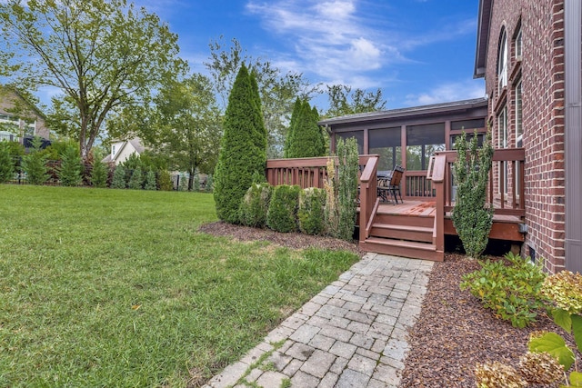 view of yard with a sunroom and a deck