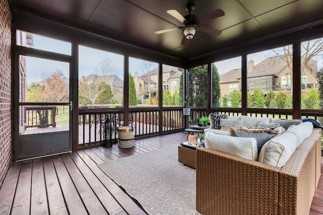 sunroom / solarium featuring ceiling fan