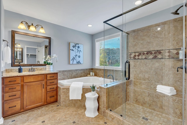 bathroom with tile patterned floors, vanity, and plus walk in shower