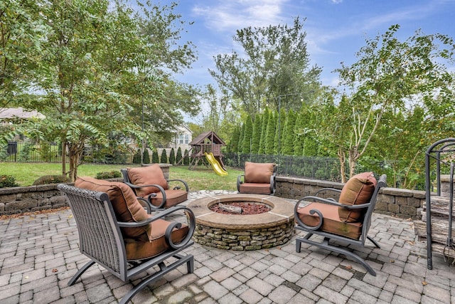 view of patio with a fire pit and a playground