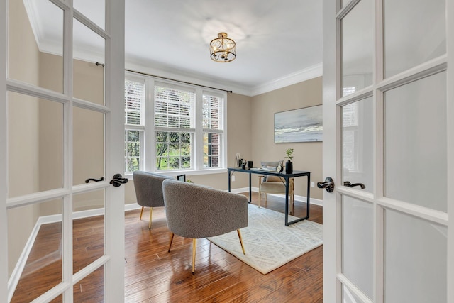 office with wood-type flooring, ornamental molding, and french doors