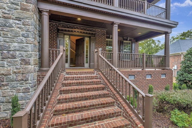 property entrance with a balcony and a porch