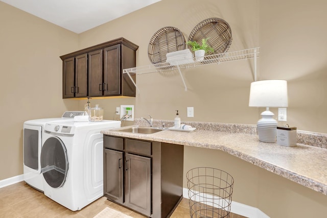 washroom with separate washer and dryer, sink, light tile patterned floors, and cabinets