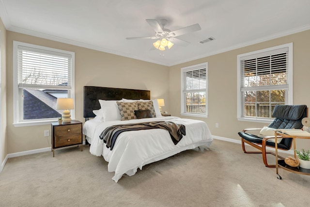 bedroom featuring multiple windows, ceiling fan, light carpet, and ornamental molding