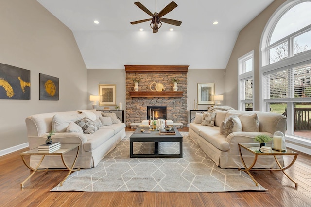 living room with a fireplace, hardwood / wood-style floors, high vaulted ceiling, and a wealth of natural light