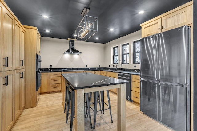 kitchen featuring light brown cabinetry, sink, black appliances, and light wood-type flooring