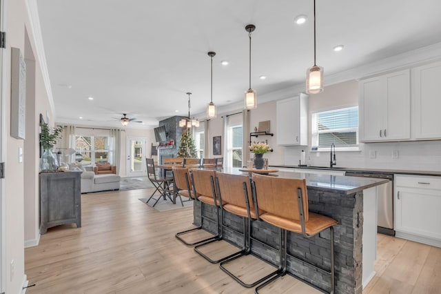 kitchen with white cabinetry, plenty of natural light, and ceiling fan