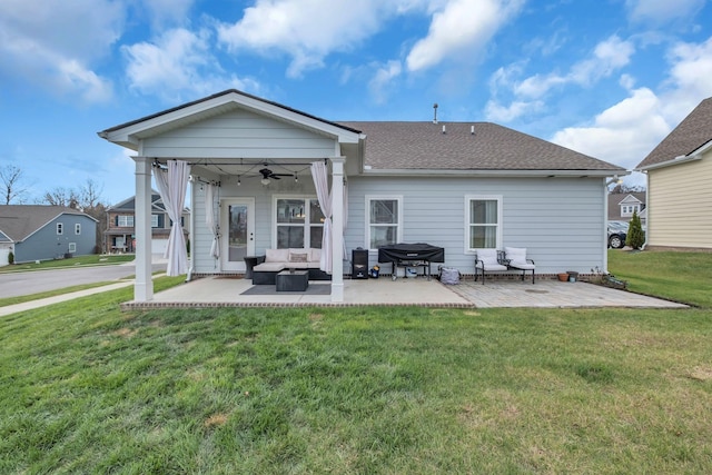 back of property with ceiling fan, a yard, a patio, and an outdoor hangout area