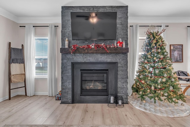 details featuring hardwood / wood-style flooring, a stone fireplace, and ornamental molding