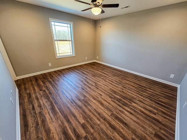 unfurnished room with ceiling fan and dark hardwood / wood-style flooring