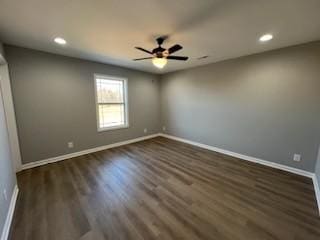 spare room with ceiling fan and dark wood-type flooring