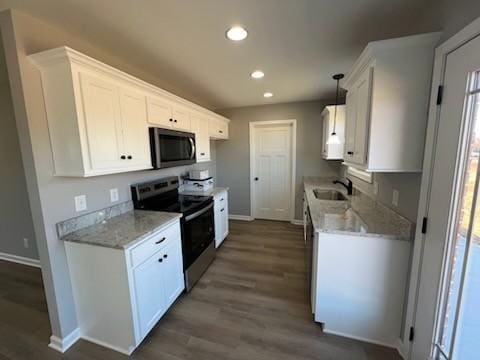 kitchen with white cabinets, decorative light fixtures, dark hardwood / wood-style flooring, and stainless steel appliances