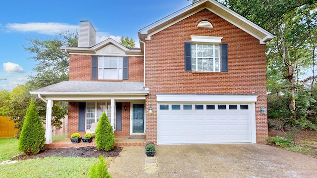 view of front property with a porch and a garage