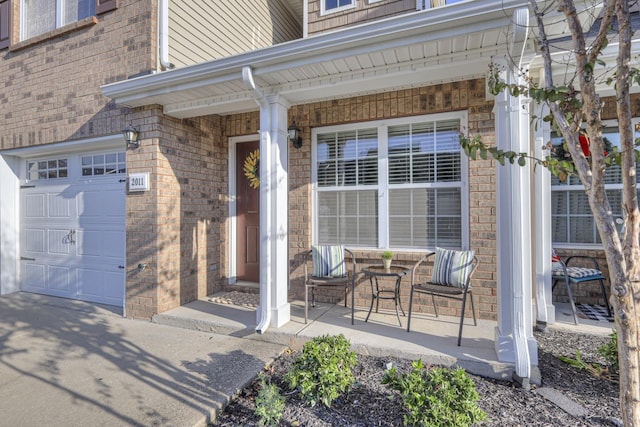 view of exterior entry featuring covered porch