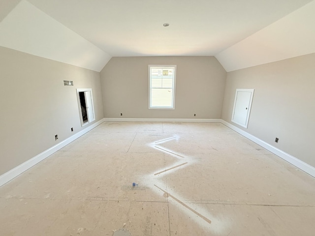 additional living space featuring lofted ceiling