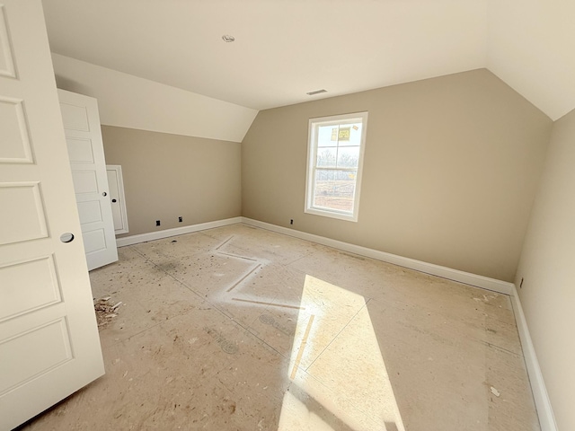 additional living space featuring lofted ceiling