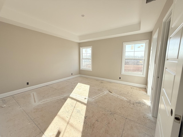 spare room featuring a raised ceiling