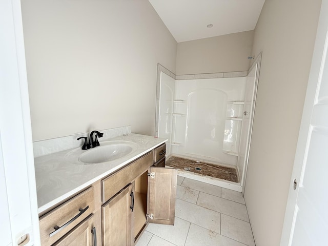 bathroom with vanity, tile patterned floors, and walk in shower