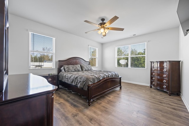 bedroom with ceiling fan and dark hardwood / wood-style flooring