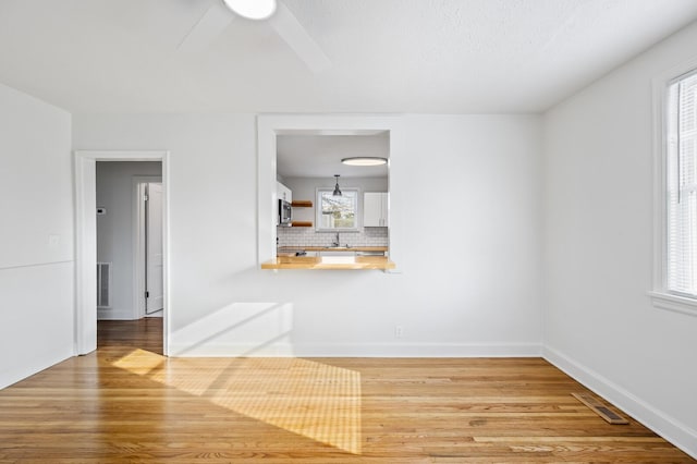 spare room featuring hardwood / wood-style floors and sink