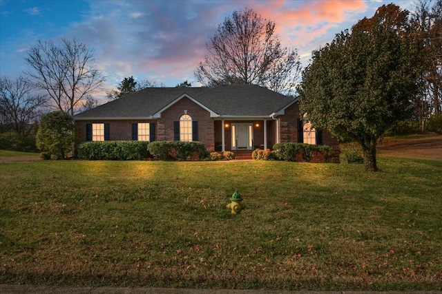 ranch-style house featuring a lawn