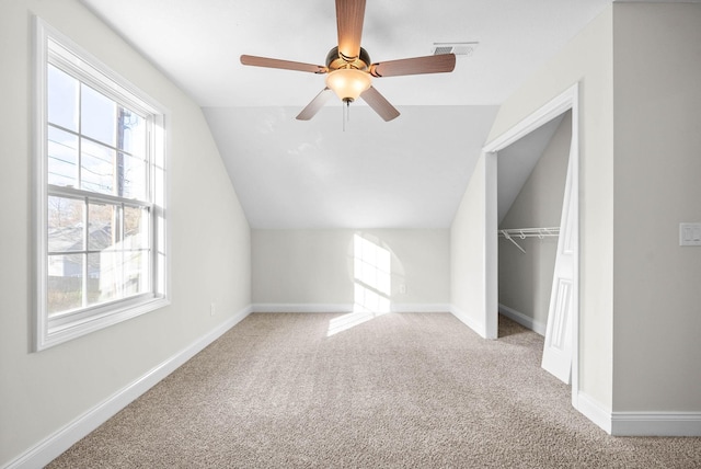 additional living space with carpet flooring, ceiling fan, and lofted ceiling