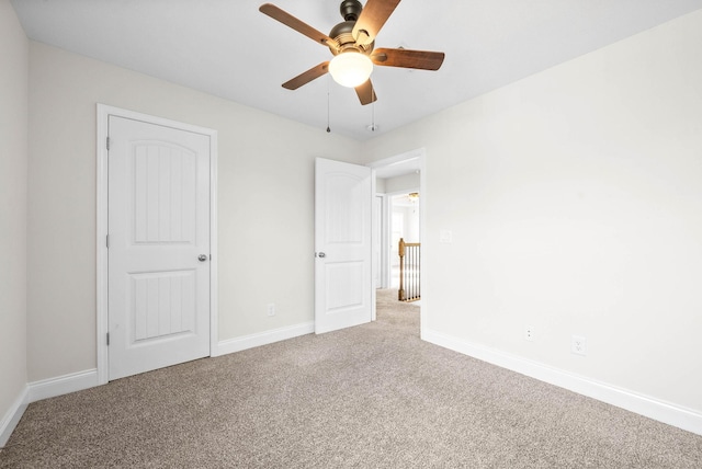 unfurnished bedroom featuring carpet and ceiling fan