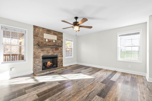 unfurnished living room with ceiling fan, a fireplace, and hardwood / wood-style flooring