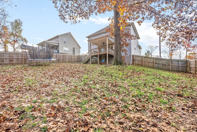 view of yard featuring ceiling fan and a trampoline