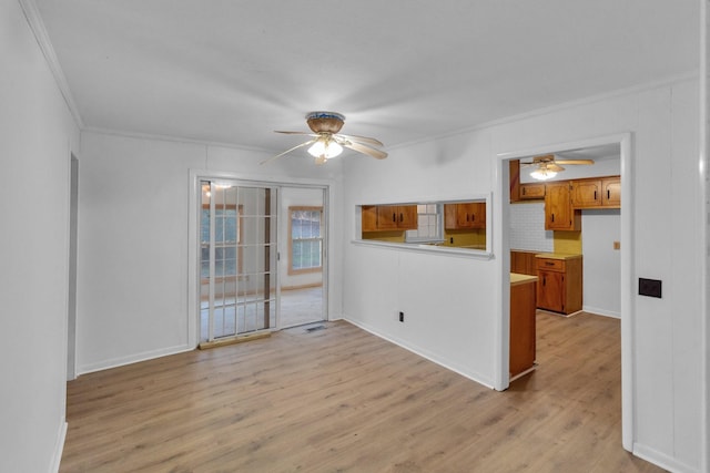 empty room featuring light hardwood / wood-style flooring and ornamental molding