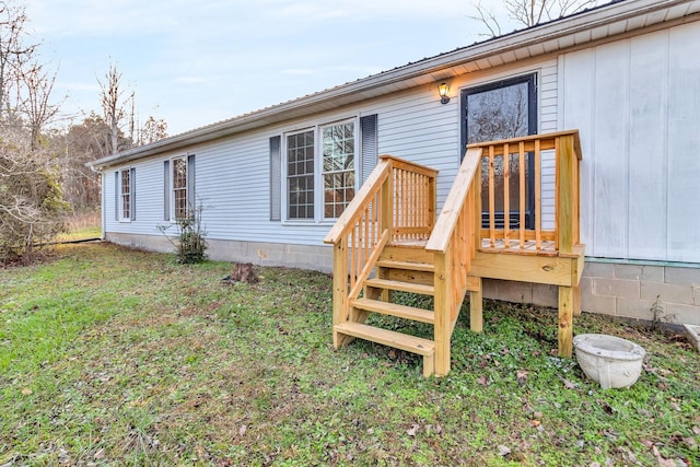 rear view of house featuring a lawn and a deck