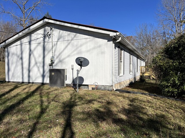 view of home's exterior with a yard and central AC