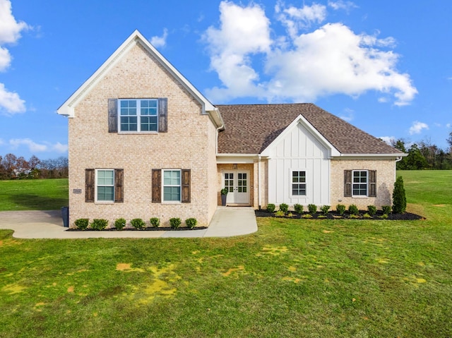 view of front of house featuring a front yard and french doors