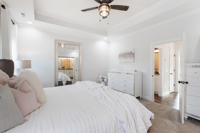 bedroom with hardwood / wood-style flooring, ceiling fan, a raised ceiling, and crown molding