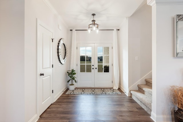 doorway featuring french doors, dark hardwood / wood-style floors, an inviting chandelier, and ornamental molding