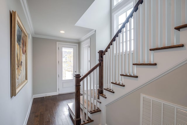 foyer entrance with dark hardwood / wood-style floors and crown molding