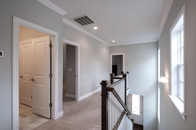 hallway with light carpet and crown molding