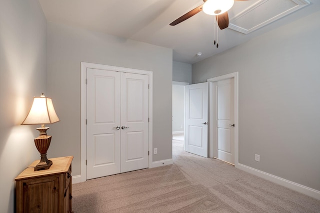 bedroom featuring ceiling fan, a closet, and light colored carpet