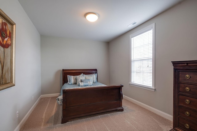 bedroom with light colored carpet