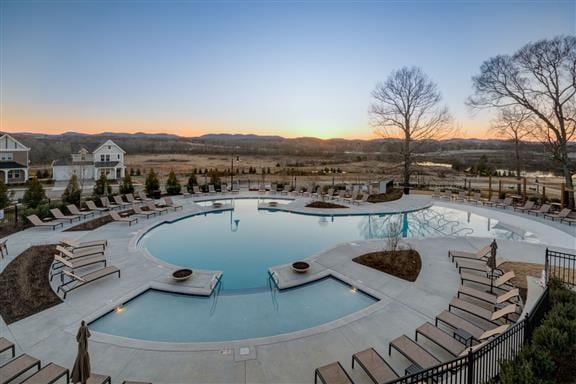 view of pool at dusk